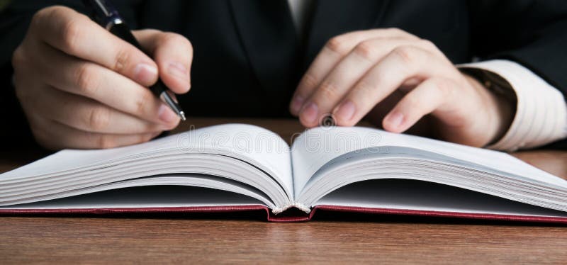 O escritor escreve uma pena no documento fotografia de stock O escritor escreve uma pena no documento fotografia de stock