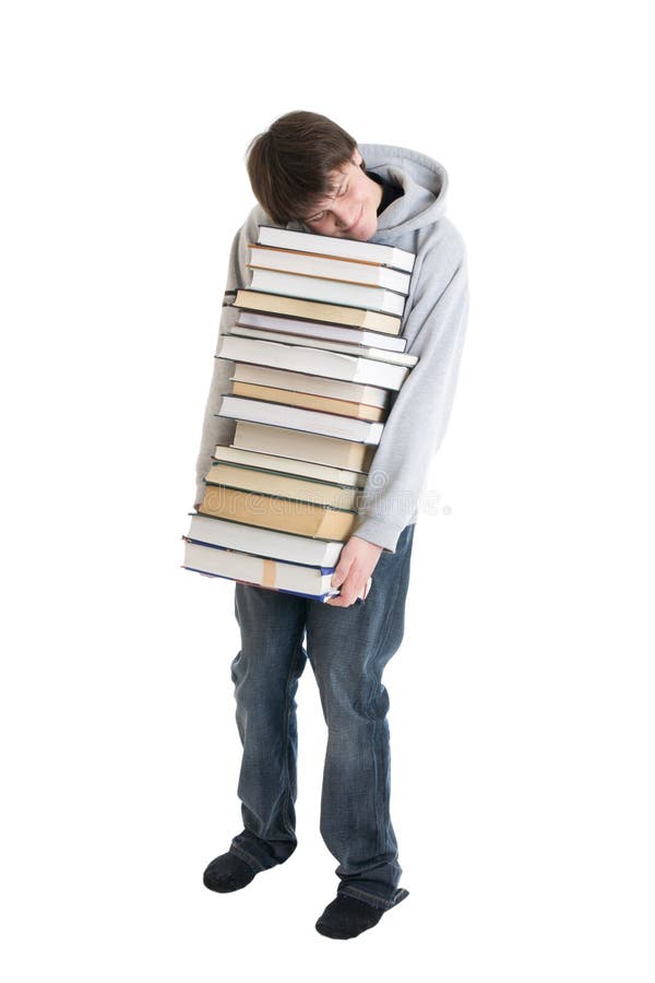 O estudante novo com uma pilha dos livros isolados foto de stock royalty free O estudante novo com uma pilha dos livros isolados foto de stock royalty free