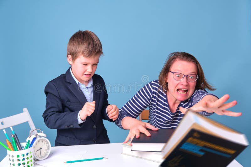 The boy refuses to learn by kicking a book. Mom and problem son for lessons. The boy refuses to learn by kicking a book. Mom and problem son for lessons.