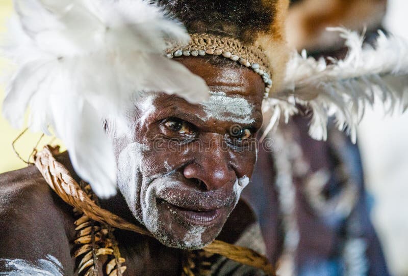 INDONESIA, IRIAN JAYA, ASMAT PROVINCE, JOW VILLAGE - JUNE 12: The Portrait Asmat warrior with a traditional painting and coloring on a face. INDONESIA, IRIAN JAYA, ASMAT PROVINCE, JOW VILLAGE - JUNE 12: The Portrait Asmat warrior with a traditional painting and coloring on a face.