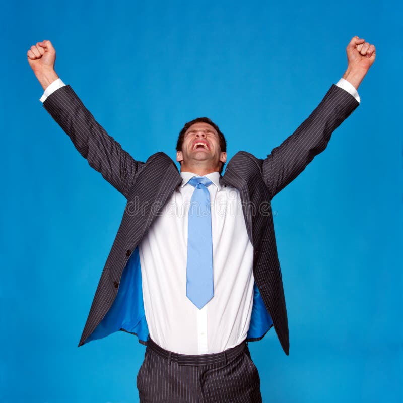 Businessman celebrating with his arms raised in the air, blue background. Businessman celebrating with his arms raised in the air, blue background.