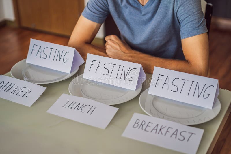 The man is engaged in intermittent fasting for health.. Intermittent fasting concept, top view. The man is engaged in intermittent fasting for health.. Intermittent fasting concept, top view.