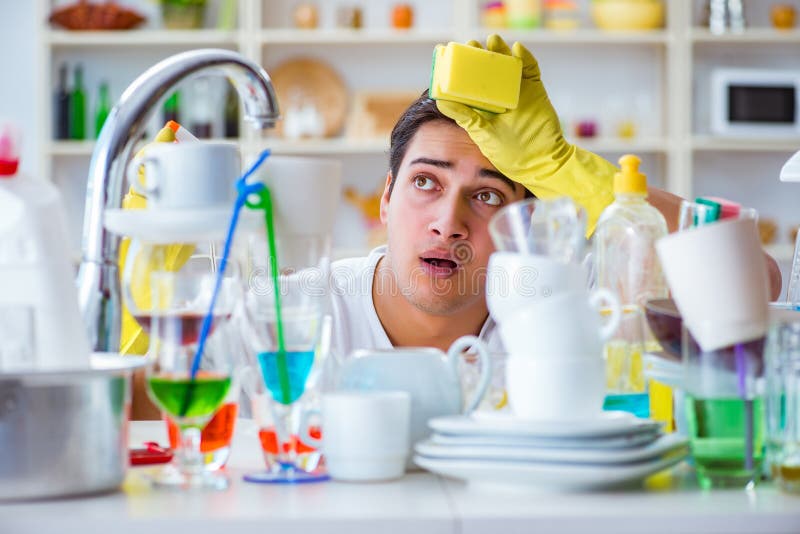 Man frustrated at having to wash dishes. Man frustrated at having to wash dishes