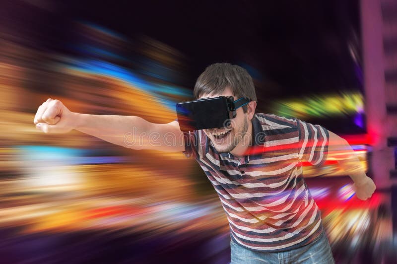 Happy young man is playing racing videogame in 3D virtual reality simulator using headset. Flying in virtual reality. Happy young man is playing racing videogame in 3D virtual reality simulator using headset. Flying in virtual reality.