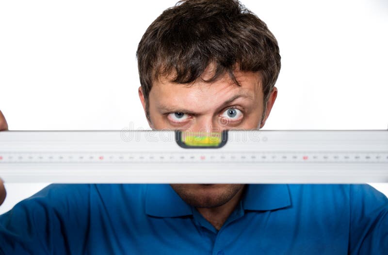 Man looks at the spirit level on white background. Man looks at the spirit level on white background