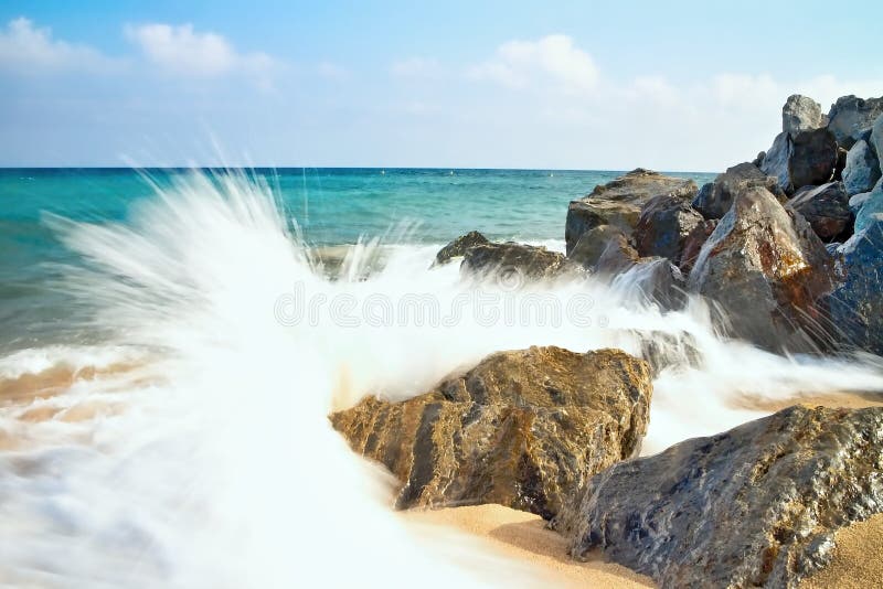 O mar acena batendo a praia rochosa em Malgrat de março, Espanha imagem de stock O mar acena batendo a praia rochosa em Malgrat de março, Espanha imagem de stock