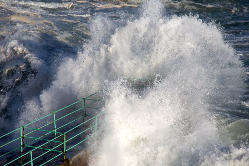 Rough Sea Waves Crashing Over a Pier, mediterranean sea, ligurian coast, Italy, Europe. Rough Sea Waves Crashing Over a Pier, mediterranean sea, ligurian coast, Italy, Europe