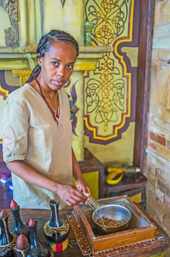 KIEV, UKRAINE - JUNE 4, 2017: The hand roasting coffee beans in a pan for the traditional Ethiopian coffee ceremony, on June 4 in Kiev. KIEV, UKRAINE - JUNE 4, 2017: The hand roasting coffee beans in a pan for the traditional Ethiopian coffee ceremony, on June 4 in Kiev.