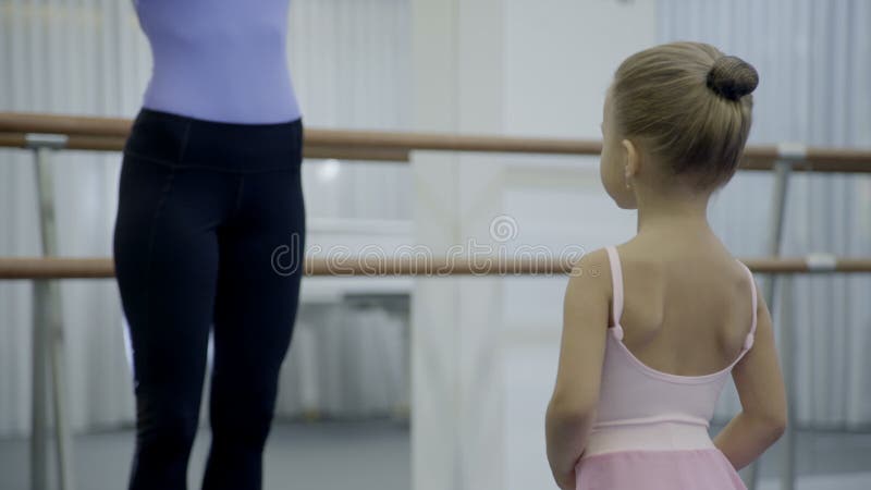 O professor fêmea ensina a menina na escola do bailado