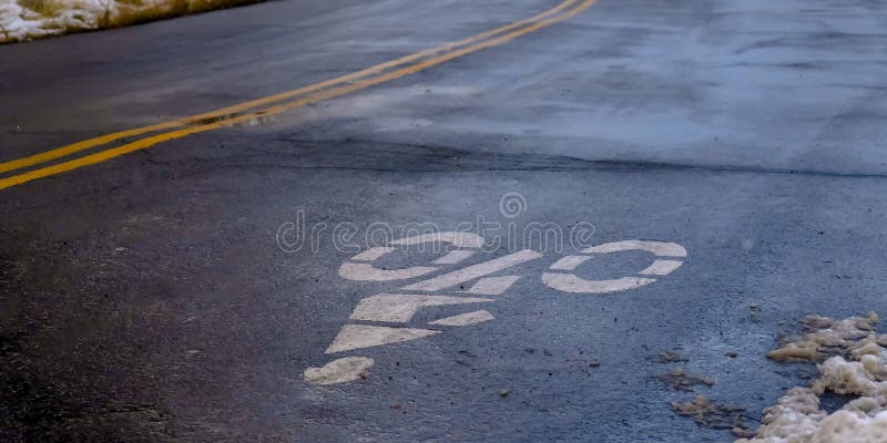 O sinal claro da pista de bicicleta do panorama pintou em uma estrada do inverno em Utá imagens de stock O sinal claro da pista de bicicleta do panorama pintou em uma estrada do inverno em Utá imagens de stock