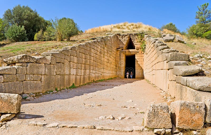 MYCENAE, GREECE - OCTOBER 10, 2013: The Treasury of Atreus or Tomb of Agamemnon is an impressive tholos tomb on the Panagitsa Hill, on October 10 in Mycenae, Greece. MYCENAE, GREECE - OCTOBER 10, 2013: The Treasury of Atreus or Tomb of Agamemnon is an impressive tholos tomb on the Panagitsa Hill, on October 10 in Mycenae, Greece.