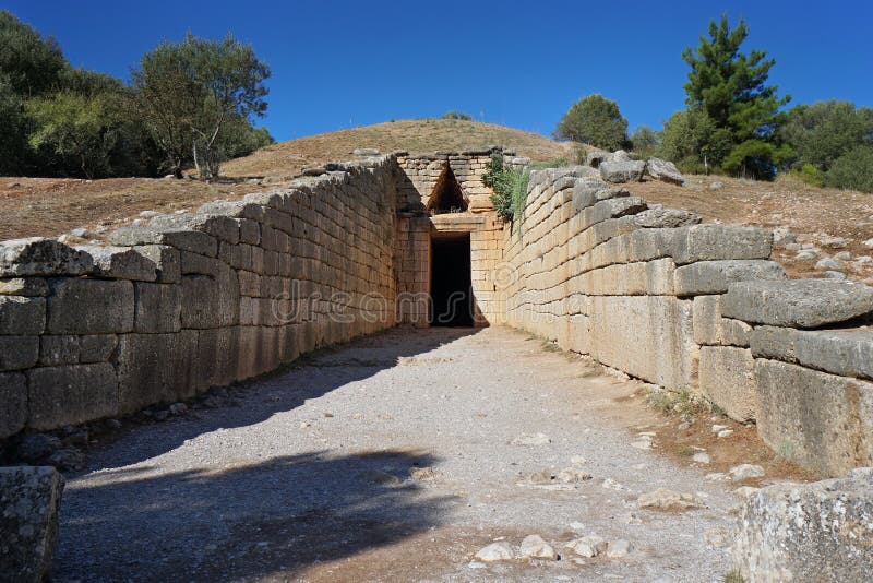 Entrance to the tomb called the treasure of Atreus in Mycenae, Greece, north, ruin, landmark, rough, vintage, artifact, civilisation, relief, historical, building, old, ancient, gate, masonry, wall, archaeologic, antiquity, outdoors, construction, stone, ashlar, architecture, setting, blue, forest, rock, hellenic, history, tour, tourism, attraction, tree, landscape, fortress, citadel, europa, castle, gateway, nature, travel, archaeology, sky, mountain, fortification, greek, lion. Entrance to the tomb called the treasure of Atreus in Mycenae, Greece, north, ruin, landmark, rough, vintage, artifact, civilisation, relief, historical, building, old, ancient, gate, masonry, wall, archaeologic, antiquity, outdoors, construction, stone, ashlar, architecture, setting, blue, forest, rock, hellenic, history, tour, tourism, attraction, tree, landscape, fortress, citadel, europa, castle, gateway, nature, travel, archaeology, sky, mountain, fortification, greek, lion