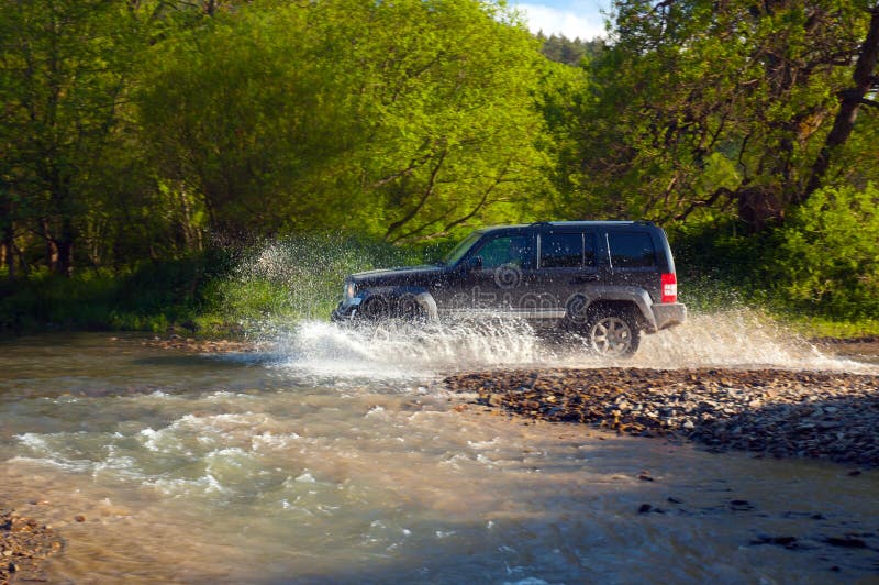 Jeep Cherokee while crossing the stream. Jeep Cherokee while crossing the stream