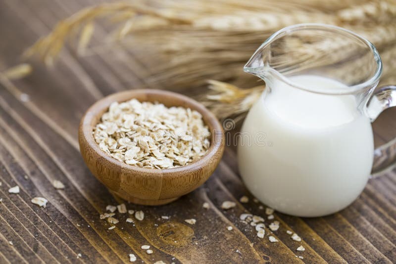 Oat milk. Vegan alternative for diary milk, healthy vegetal milk with oat flakes bowl stock photography