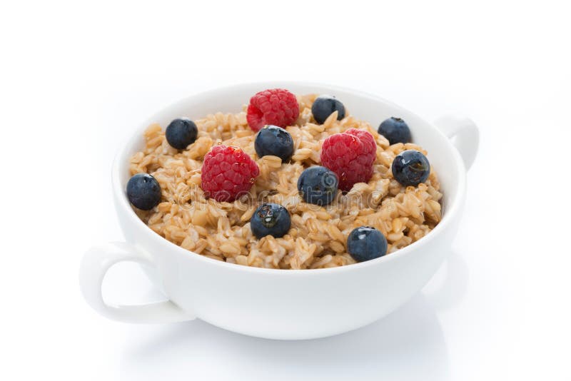 Oat porridge with berries in a bowl, isolated