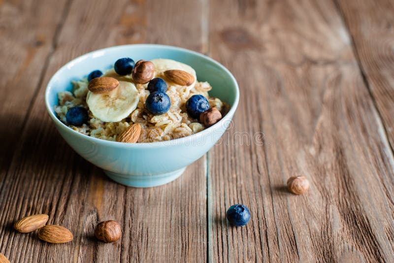 Oat porridge breakfast with nuts and berries