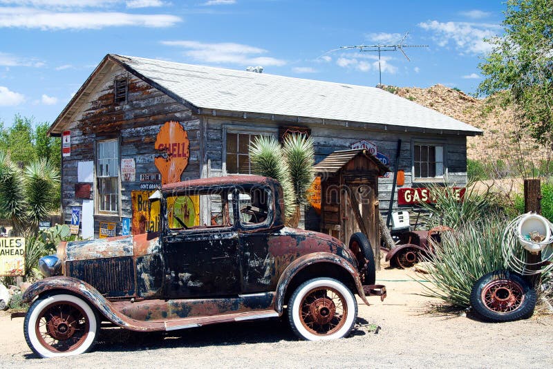 Oatman, Arizona:: American vintage car in front of abandoned wooden historic old gas station. Oatman, Arizona:: American vintage car in front of abandoned wooden historic old gas station