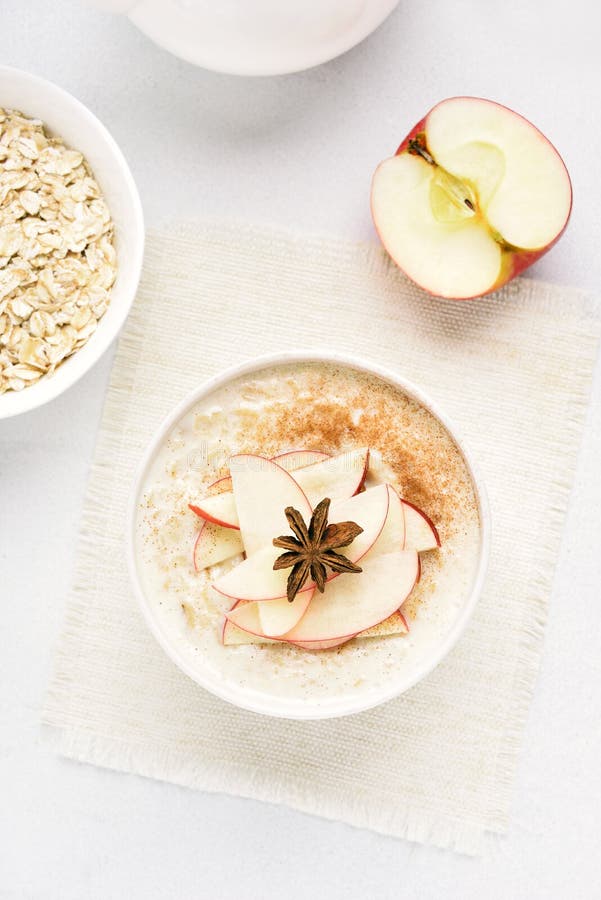 Oats porridge with red apple slices and cinnamon