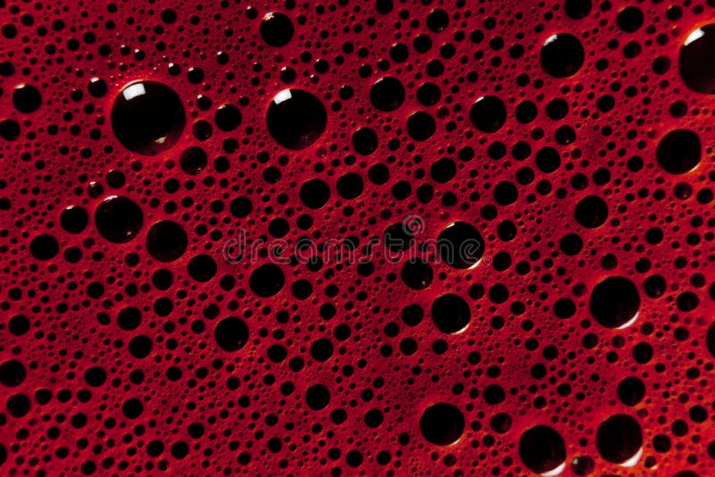 A liquid surface of dark red (wine color) bubbles. A liquid surface of dark red (wine color) bubbles.