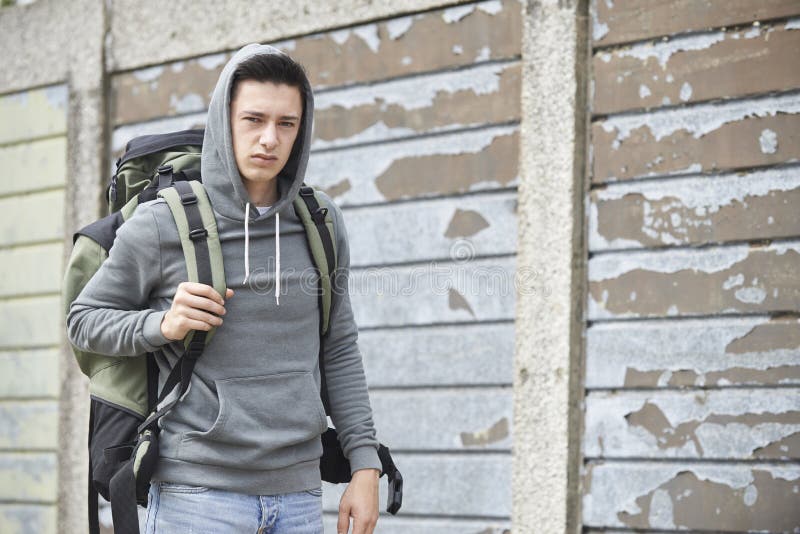 Obdachloser Teenager auf Straße mit Rucksack stockbild Obdachloser Teenager auf Straße mit Rucksack stockbild