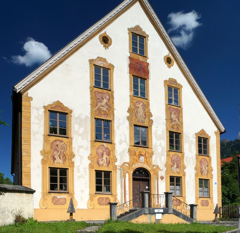 A richly decorated house in Oberammergau. The town of Oberammergau is located in the district of Garmisch-Partenkirchen in Bavaria, Germany. The town is famous for its production of a Passion Play, its woodcarvers, and the NATO School. The Oberammergau Passion Play was first performed in 1634 and is the result of a vow made by the inhabitants of the village that if God spared them from the effects of the bubonic plague then sweeping the region they would perform a passion play every ten years. The play is now performed in years ending with a zero. About half the inhabitants of Oberammergau took part in the Passion Play in 2010. This means that over 2,000 villagers brought the story of Jesus to life for the audiences that flocked in from around the world.