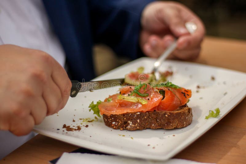 Obese at dinner table eating salmon royalty free stock image Obese at dinner table eating salmon royalty free stock image