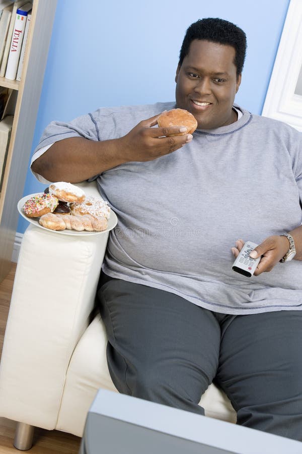 Obese Man Eating Donut. 