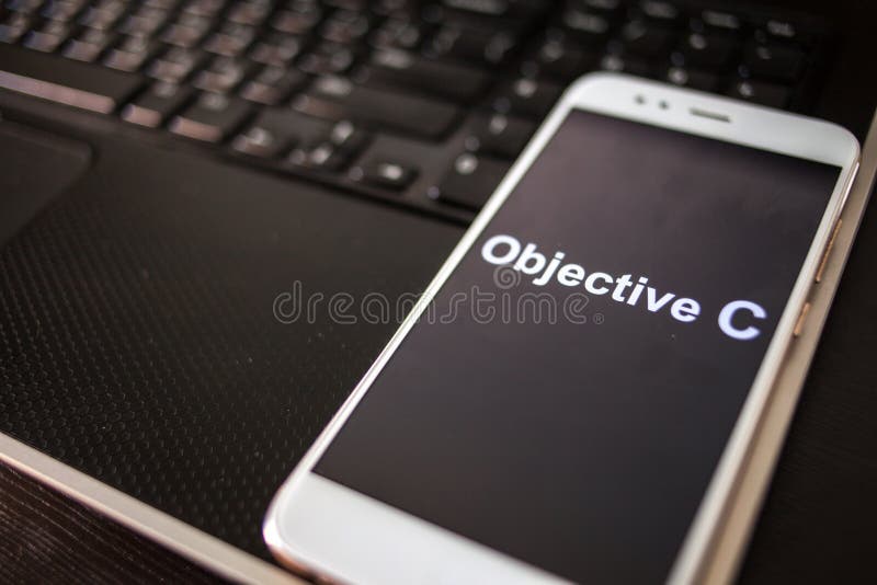 Objective C Programming language for mobile development, concept. Smartphone stock images