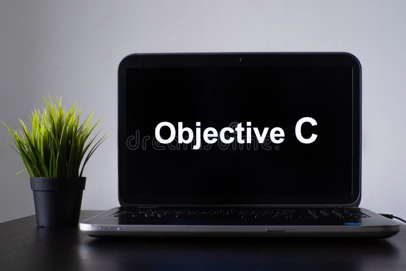 Objective C programming language. Programming training, the concept of computer courses. Laptop on the table with Objective C written on the screen