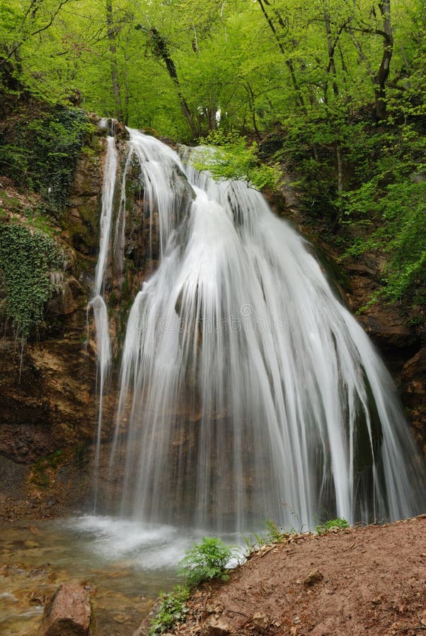 Waterfall. A picturesque stream of falling water in mountains of the Crimean peninsula. Waterfall. A picturesque stream of falling water in mountains of the Crimean peninsula