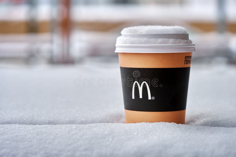 Obninsk, Russia - January 4,2019. Mcdonald`s paper cup of coffee standing on the table covered with snow stock photography Obninsk, Russia - January 4,2019. Mcdonald`s paper cup of coffee standing on the table covered with snow stock photography