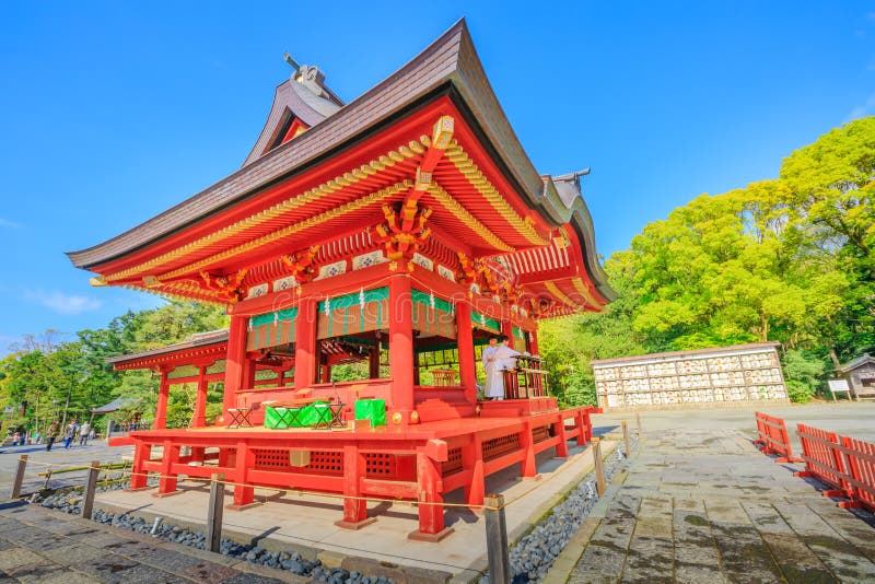 Kamakura, Japan - April 23, 2017: two monks inside Lower Worship Hall at Tsurugaoka Hachiman, the most important Shinto shrine in the city of Kamakura, Kanagawa Prefecture. Springtime in the blue sky. Kamakura, Japan - April 23, 2017: two monks inside Lower Worship Hall at Tsurugaoka Hachiman, the most important Shinto shrine in the city of Kamakura, Kanagawa Prefecture. Springtime in the blue sky.