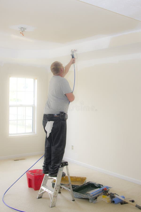 Contract painter updating colors of walls and painting ceilings bright white to speed up selling of home. Contract painter updating colors of walls and painting ceilings bright white to speed up selling of home