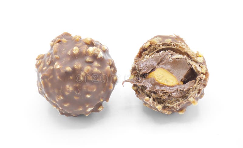 Ocala, FL 2-17-2024 Italian hazel nut premium chocolate sweet with crushed crispy wafer Ferrero Roche full and half split open showing creamy gooey inside, isolated on white background, top view. Ocala, FL 2-17-2024 Italian hazel nut premium chocolate sweet with crushed crispy wafer Ferrero Roche full and half split open showing creamy gooey inside, isolated on white background, top view