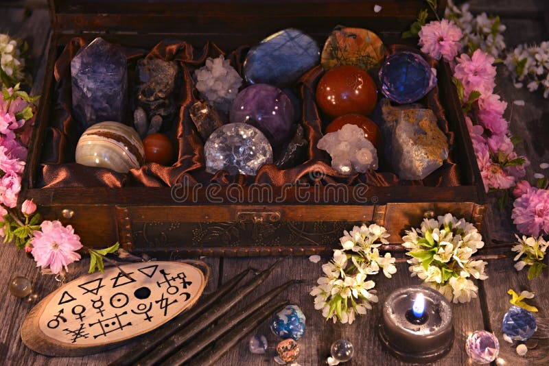 Box with magic crystals and stones, black candle and spring flowers royalty free stock photography Box with magic crystals and stones, black candle and spring flowers royalty free stock photography
