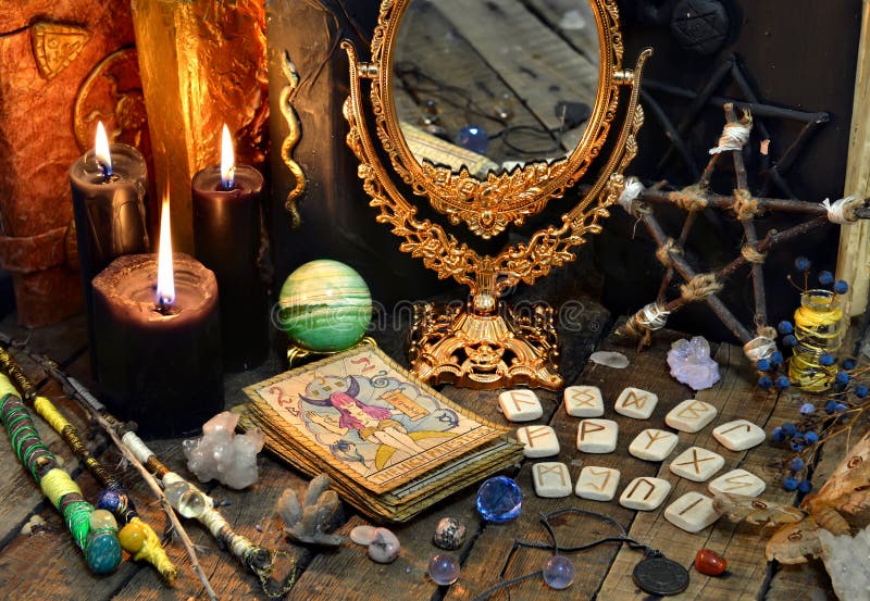 Tarot cards, magic wands, runes, black candles with mirror and old book royalty free stock image Tarot cards, magic wands, runes, black candles with mirror and old book royalty free stock image