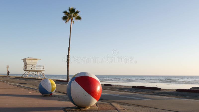 Ocean beach California USA. Ball, lifeguard tower, life guard watchtower hut, beachfront palm tree. Pacific ocean beach, Oceanside California USA. Ball
