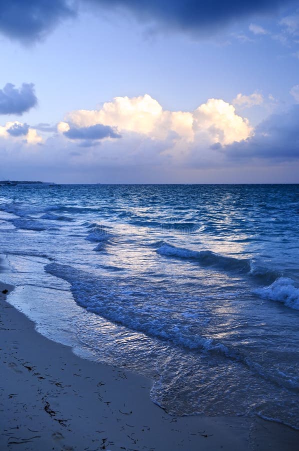 Ocean waves on beach at dusk