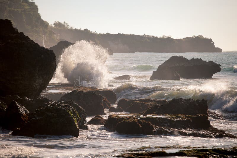 Ocean waves crashing onto the rocks in the sunset stock image Ocean waves crashing onto the rocks in the sunset stock image
