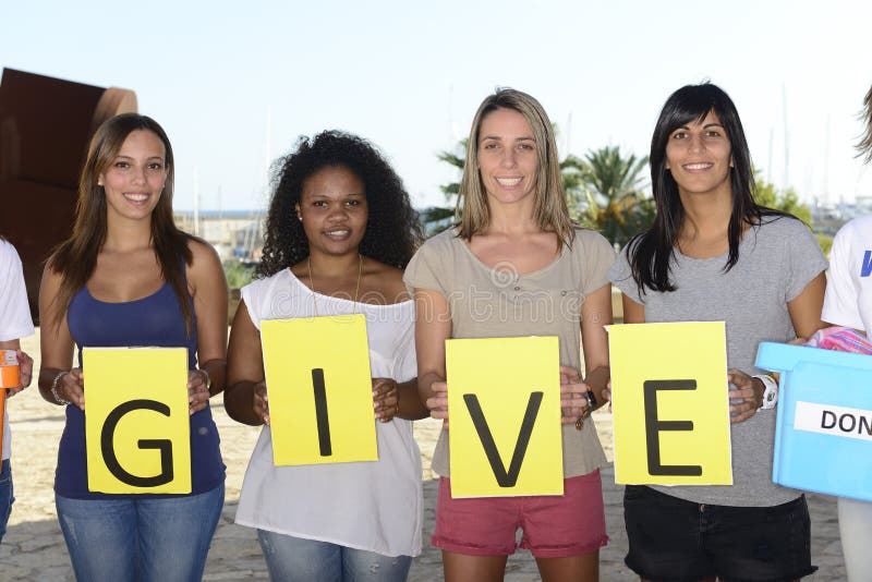 Multiethnic volunteer group with sign give. Multiethnic volunteer group with sign give