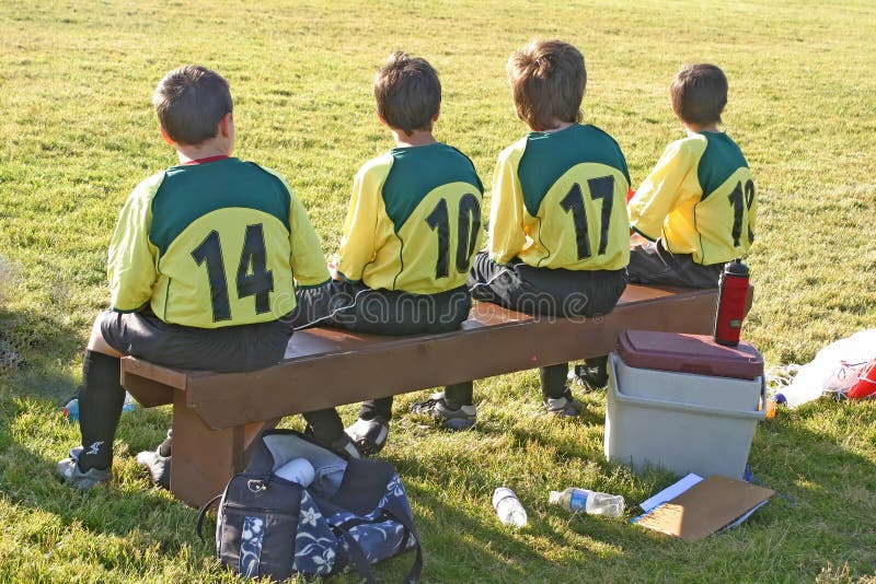 Young lads warming the bench at local soccer game. Young lads warming the bench at local soccer game