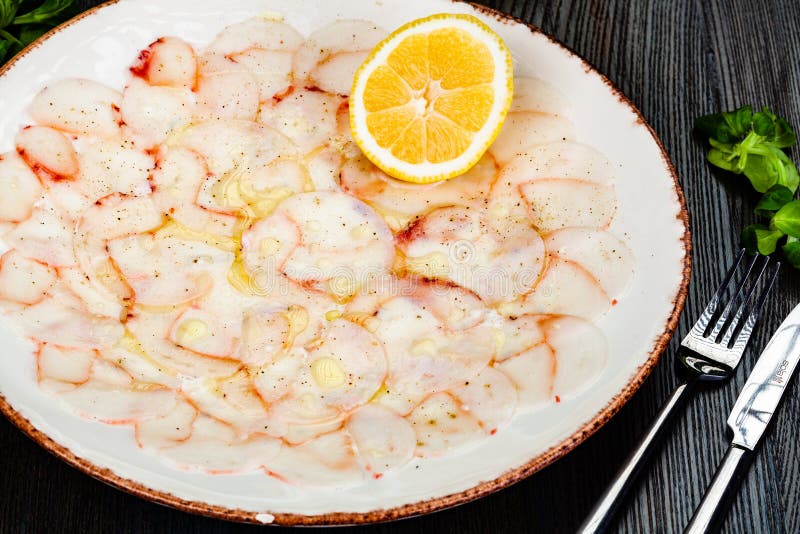 OCTOPUS CARPACCIO. Seafood Raw Octopus Slices With Olive Oil, Lemon And