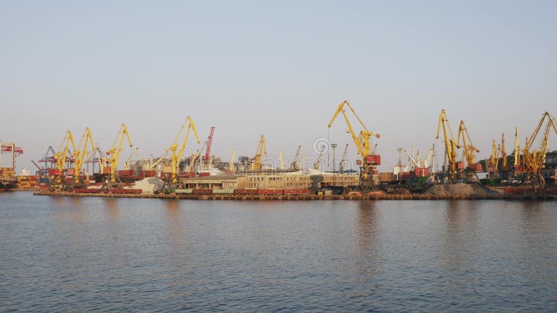 ODESSA, UKRAINE - AUG 24, 2019: Pan shot of a marine port cranes of Odessa sea commercial port in Ukraine.