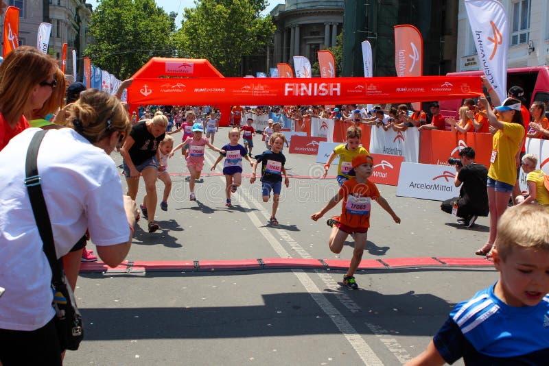 Marathon with children. Kid runners at finish line at summer maraton