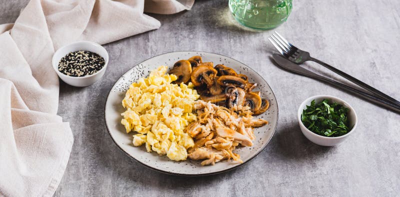 Oeufs brouillés poulet frit et champignons sur une assiette sur la table web bannière