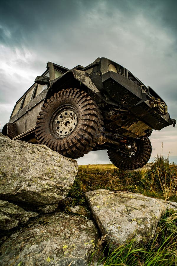 Off-road travel on mountain road. Car tire. Tire for offroad. Offroad vehicle stuck on impenetrable road after rain in the countryside