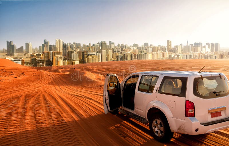 Off-road vehicle on a desert sand track and the city in the background stock image Off-road vehicle on a desert sand track and the city in the background stock image