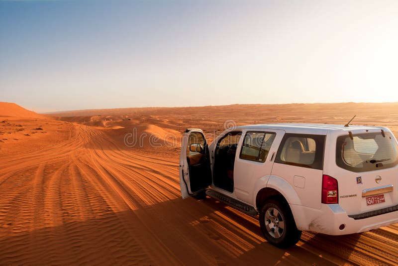 Off-road vehicle in the wahiba sands desert dunes at sunset stock photos Off-road vehicle in the wahiba sands desert dunes at sunset stock photos