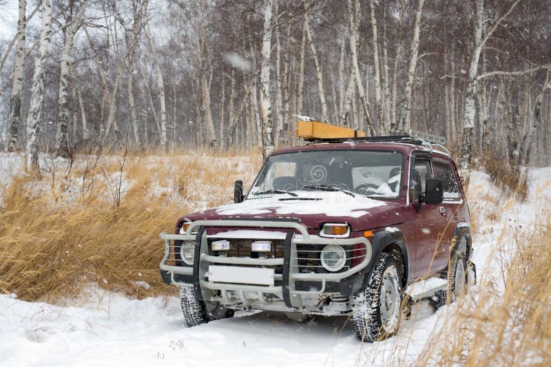 Off-road vehicle in winter forest