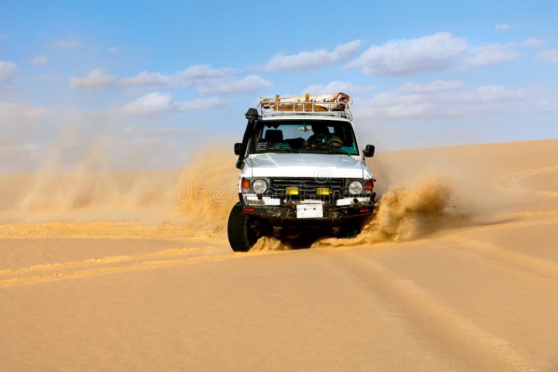 Off-road vehicles driving in Sahara sand desert